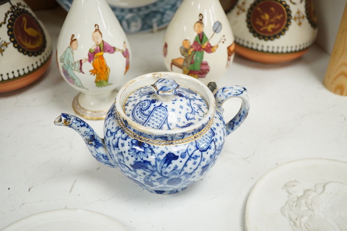 A pair of Copenhagen biscuit relief plaques of Night and Day, after Thorvaldsen, 15cm diameter, plus two pairs of vases, a blue and white plate and teapot (8)